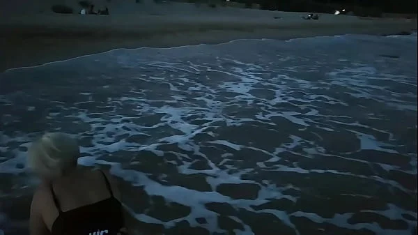 Blonde shows tits and sucks cock on a public beach