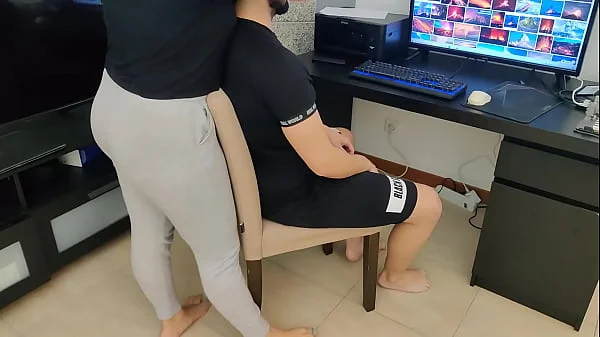 mature gives her stepson a handjob while watching porn