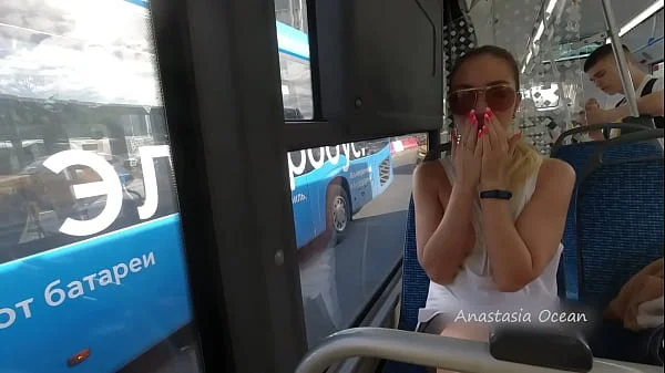 A girl rides a public bus with bare breasts